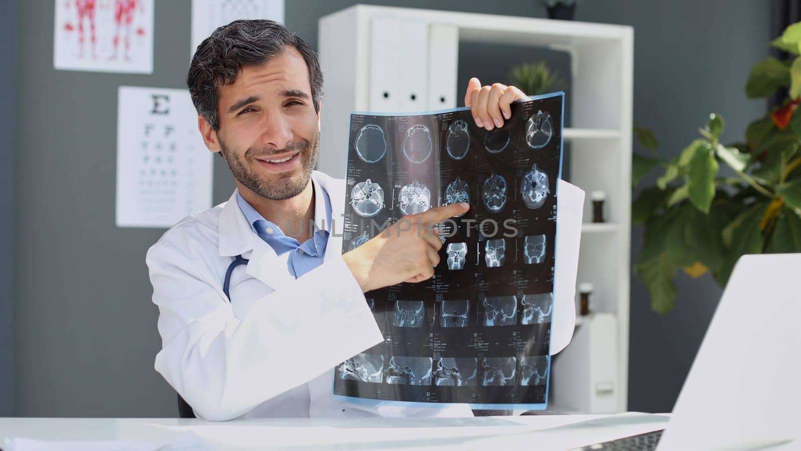 Image of male doctor looking at x-ray results by Prosto