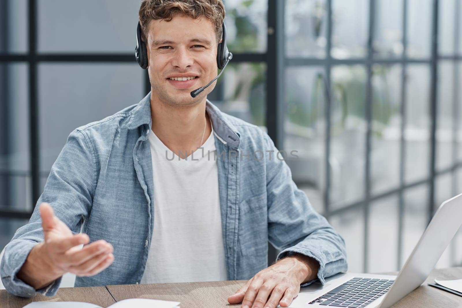 man, call center and web support communication at a computer in a office