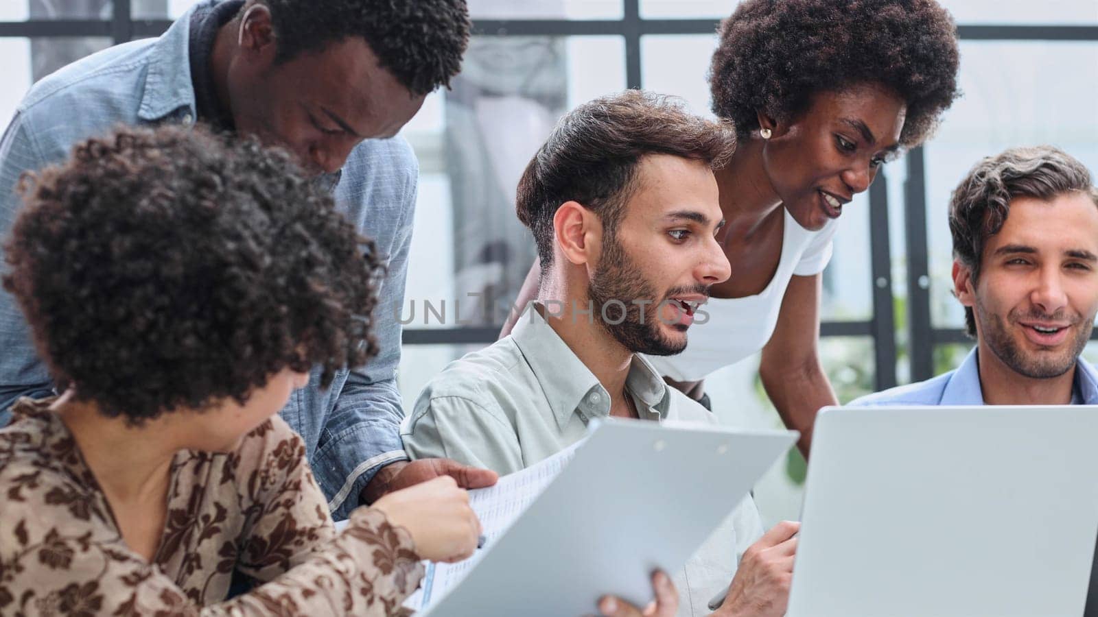 Employees working at computer together, discussing content by Prosto