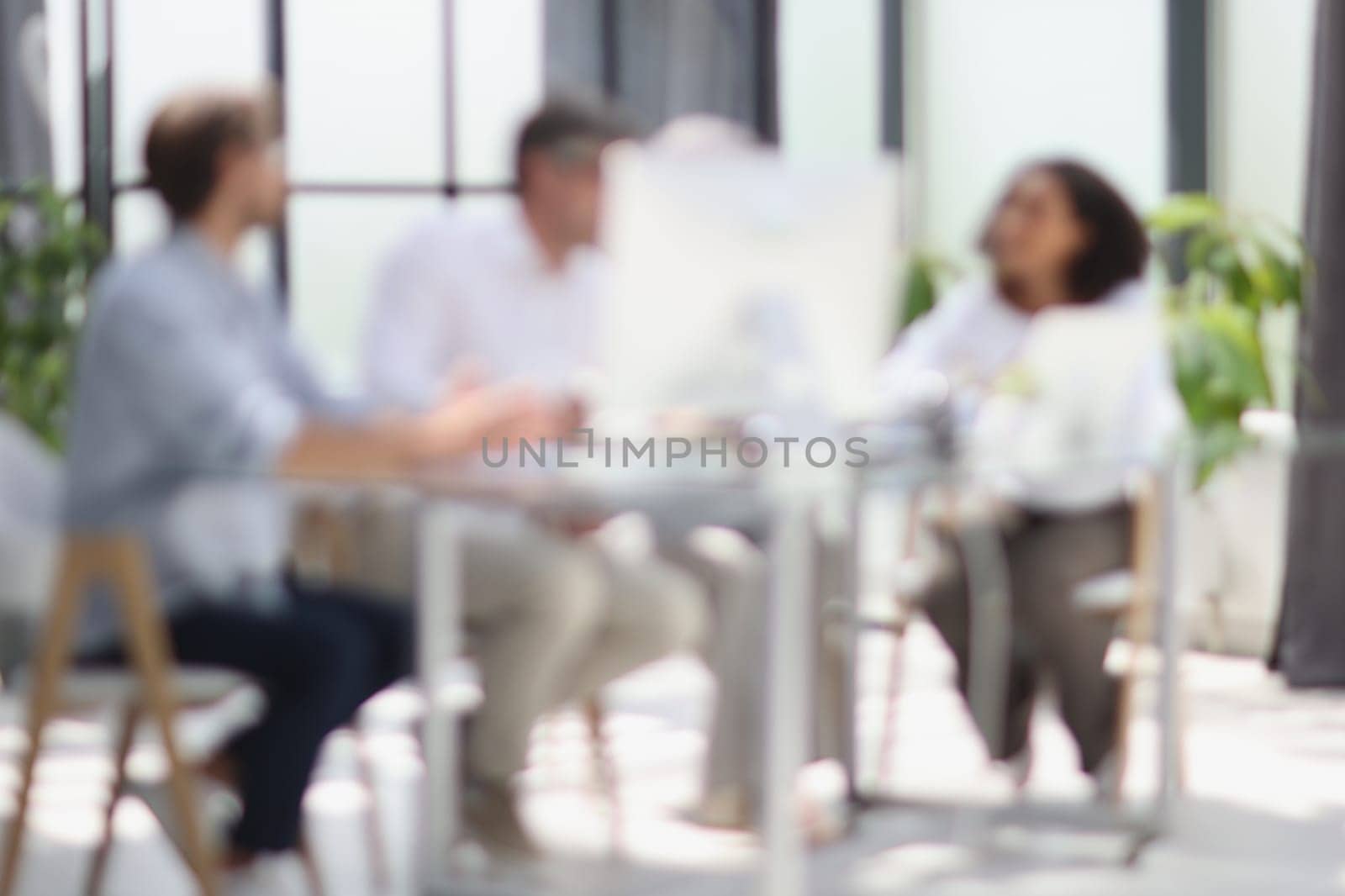 Conversation between managers and employees in the office. Blurred photo.