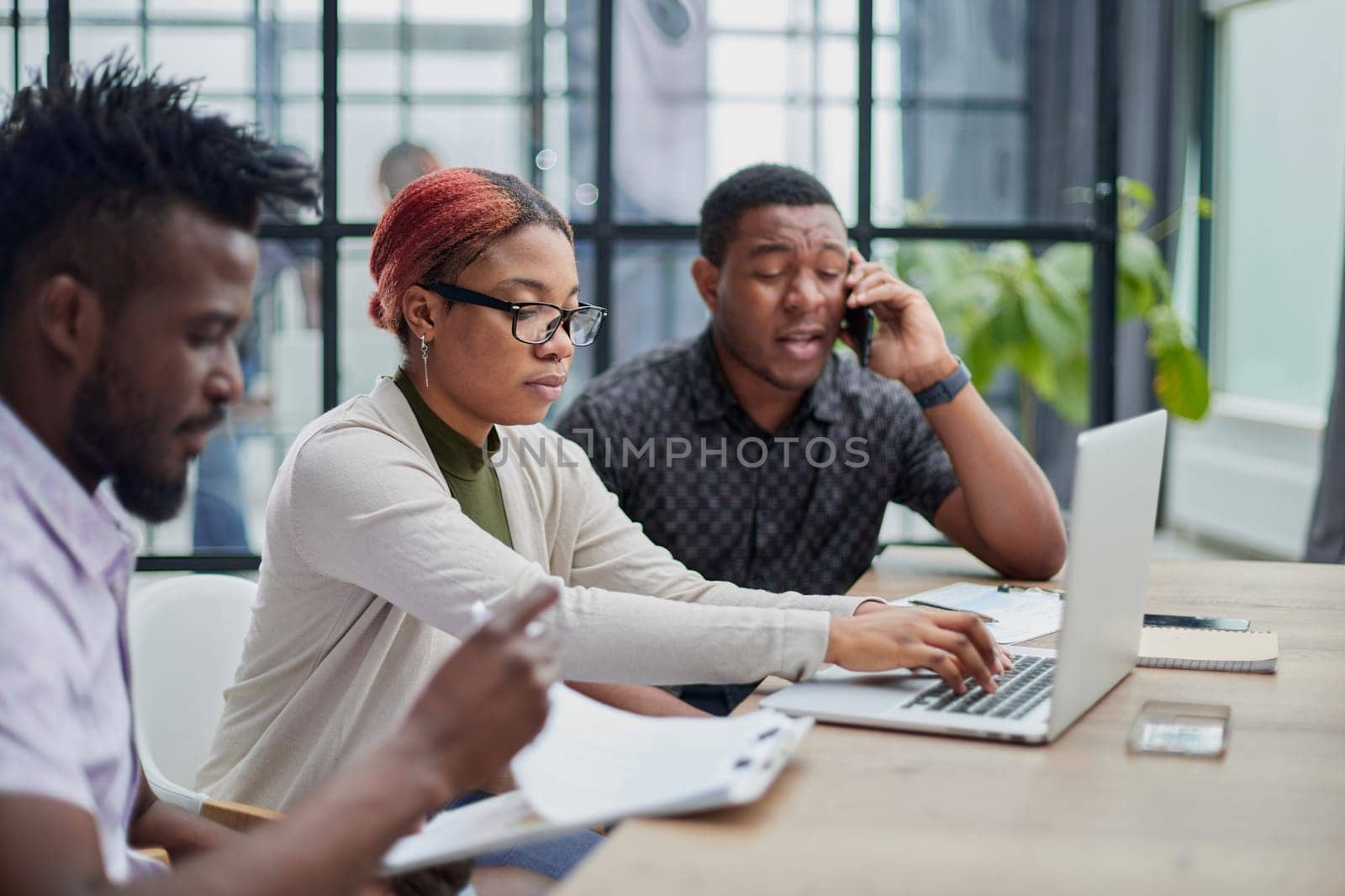 Young, motivated and experienced employees are brainstorming in the conference room.