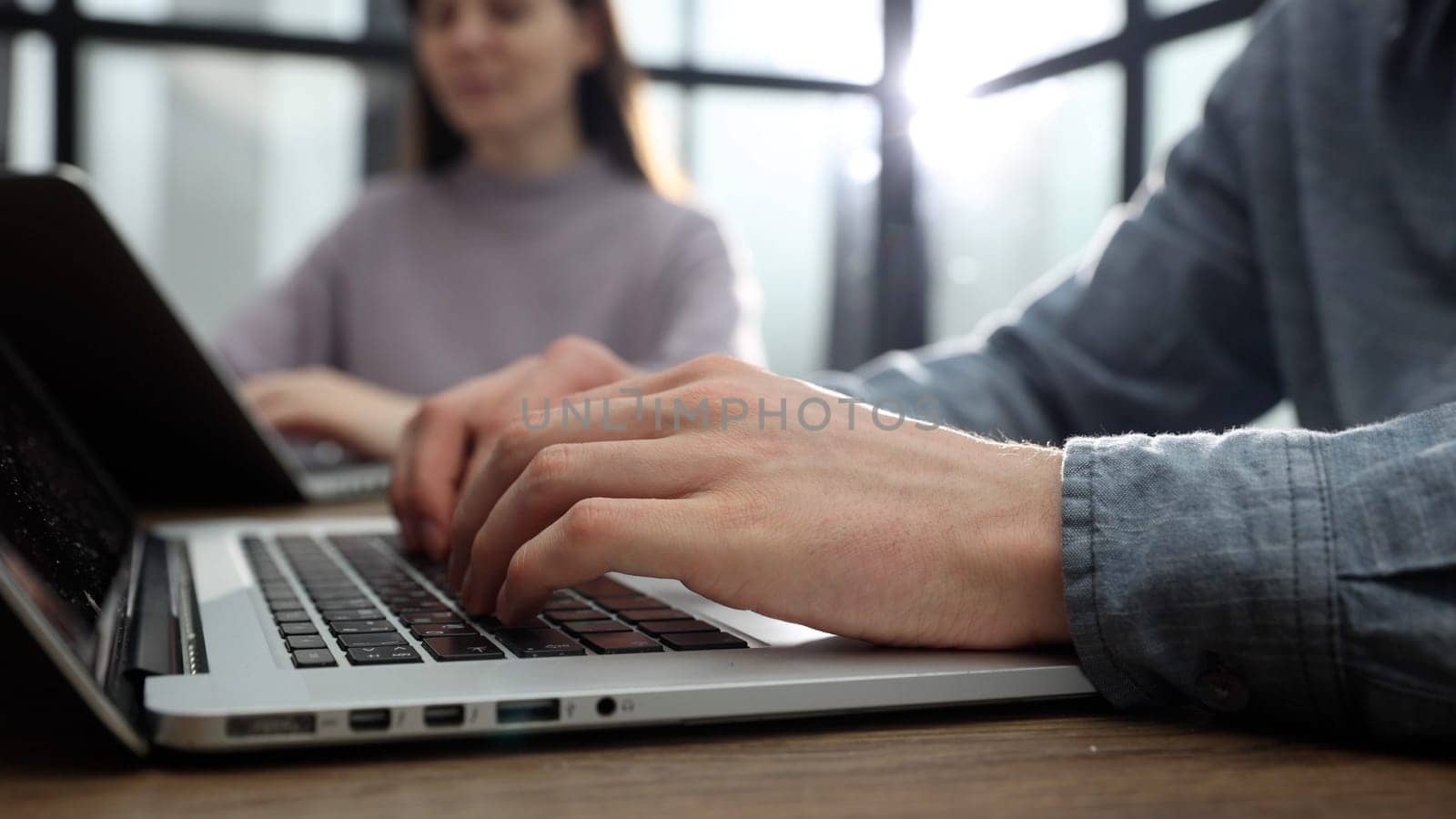 Working at a desk with a laptop in the office with a business team.