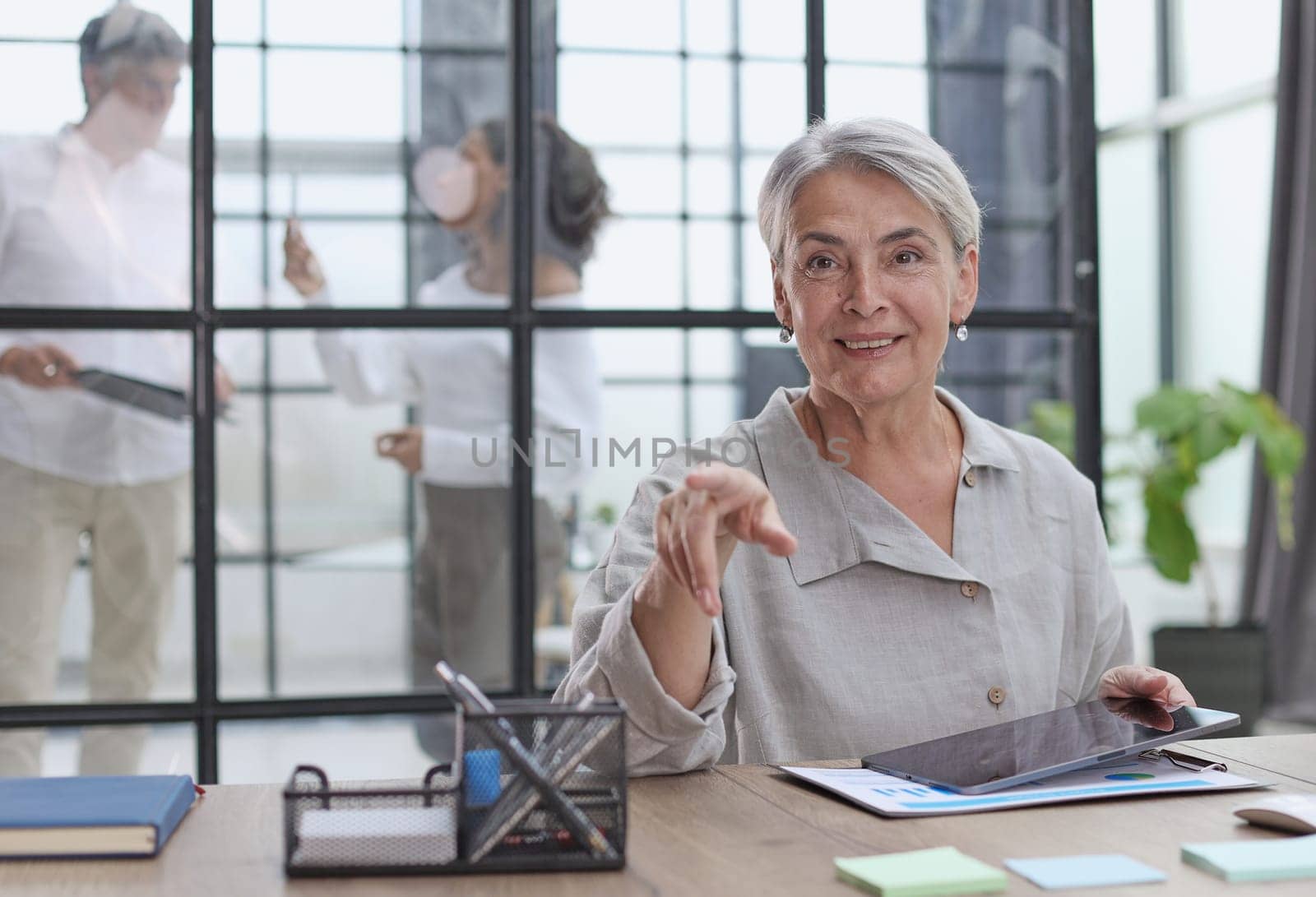 Modern mature businesswoman working at her desk