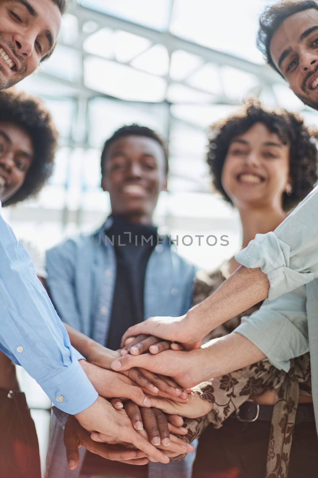 group of successful business diverse people in the office stands embracing