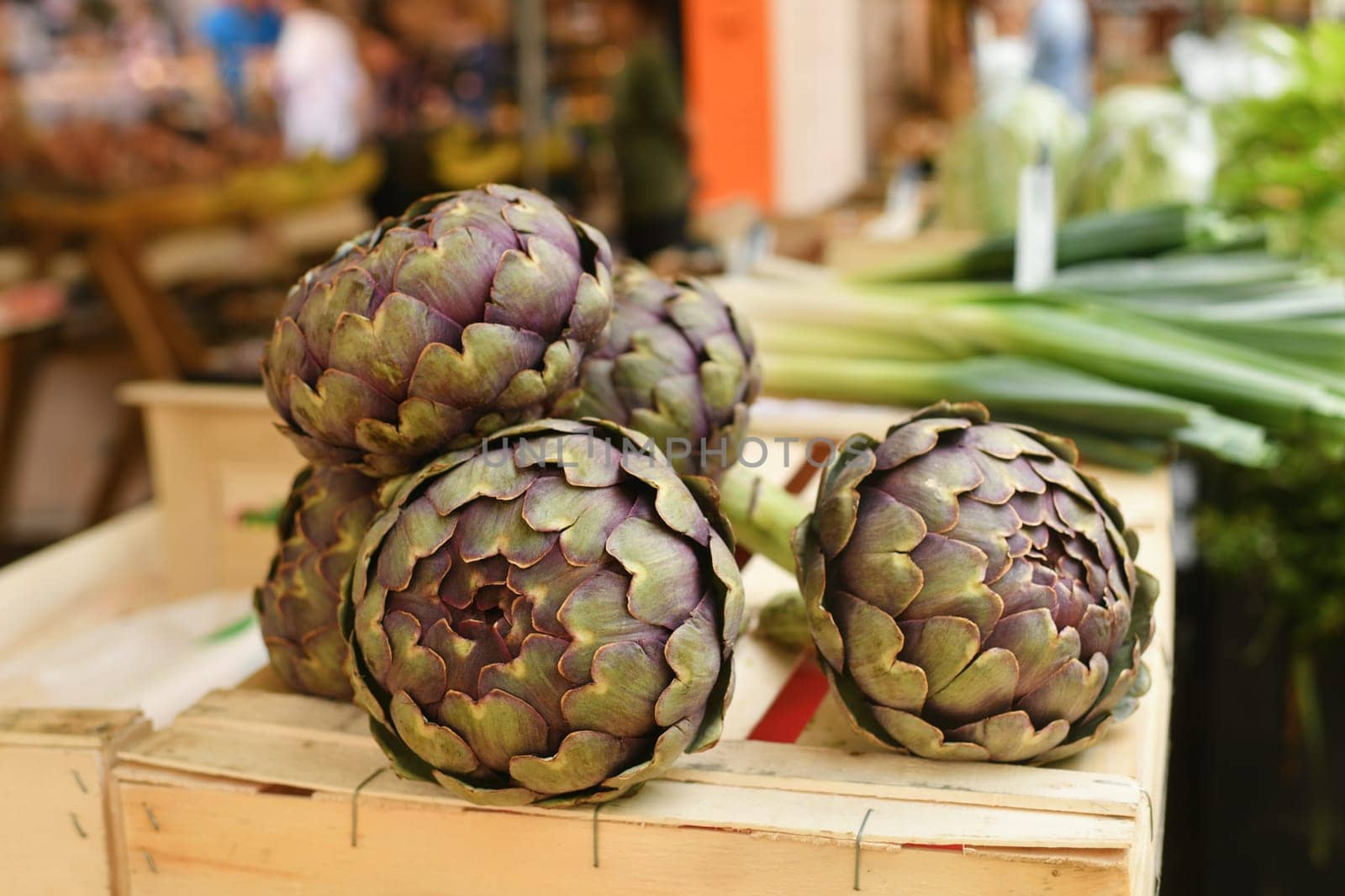 Artichokes for sale in a french market by Godi