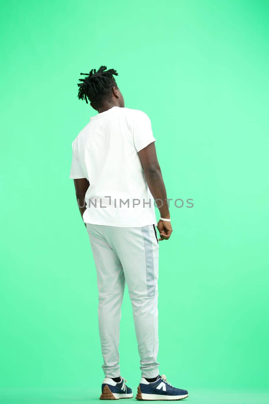 Man, full-length, on a green background.