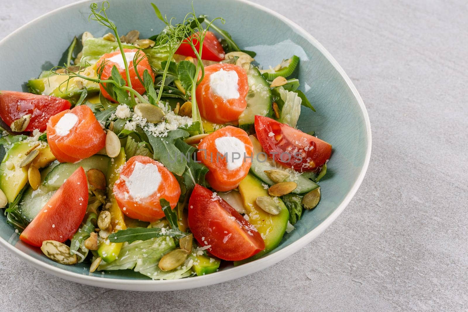 salad with salmon and cream cheese on a stone background studio food photo 4