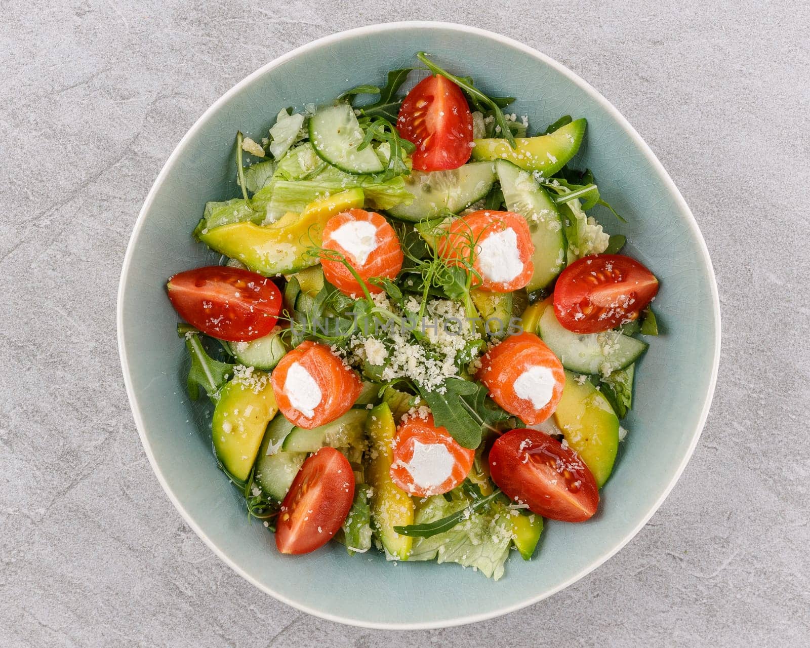 salad with salmon and cream cheese on a stone background studio food photo 2