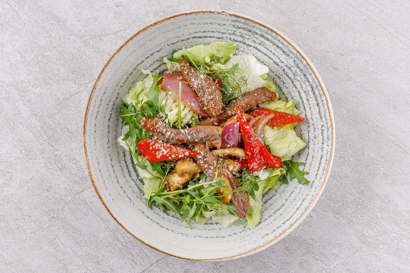 Veal salad on a stone background studio food photo