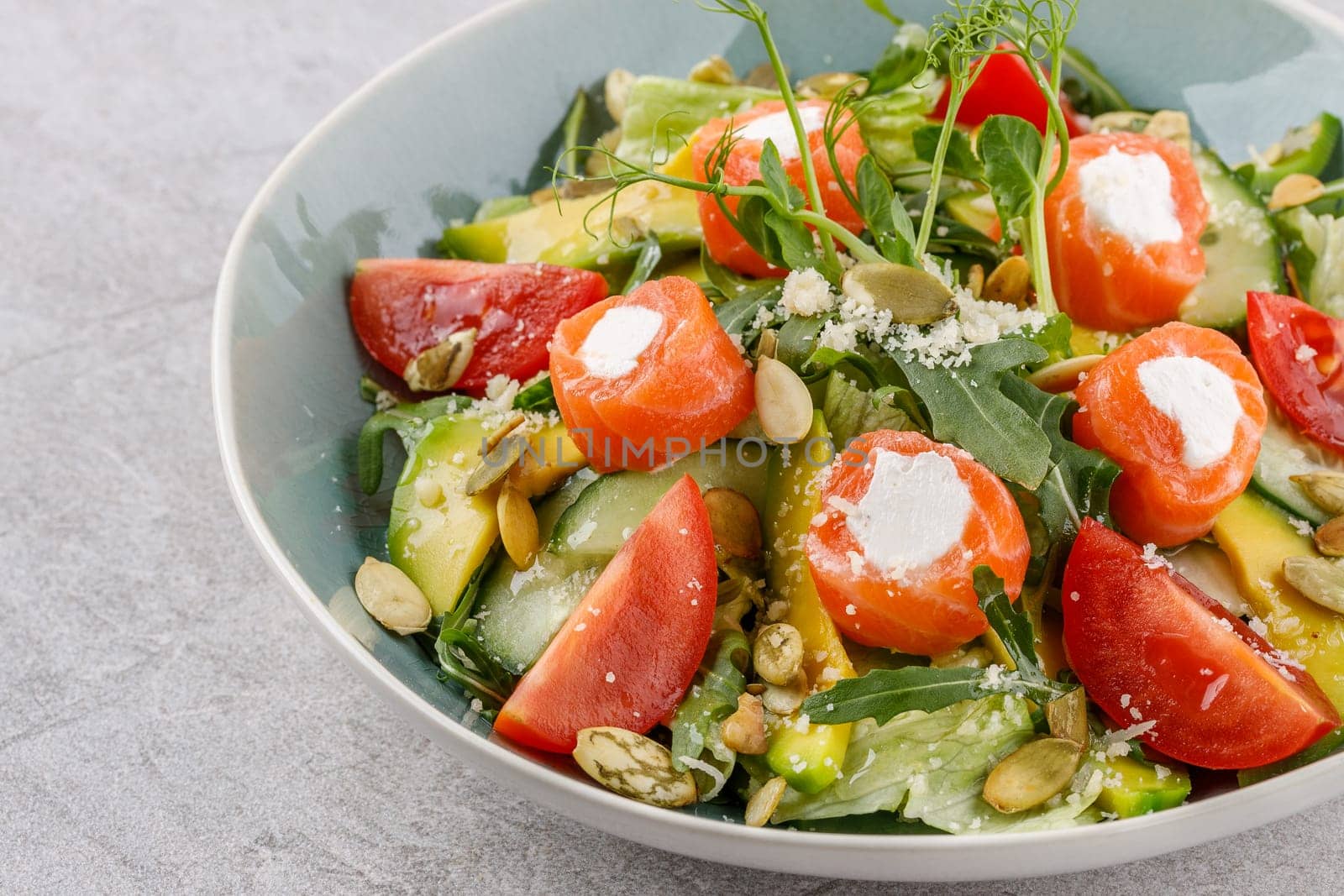 salad with salmon and cream cheese on a stone background studio food photo 5