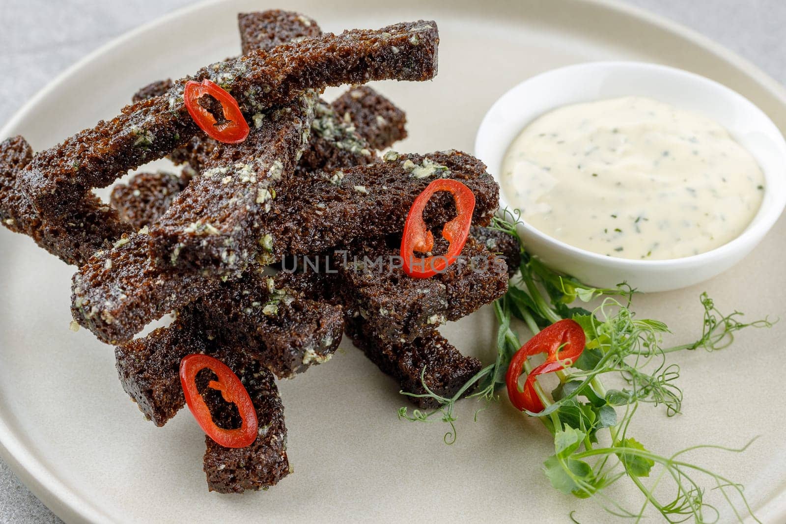fried slices of black bread on a stone background studio food photo 4