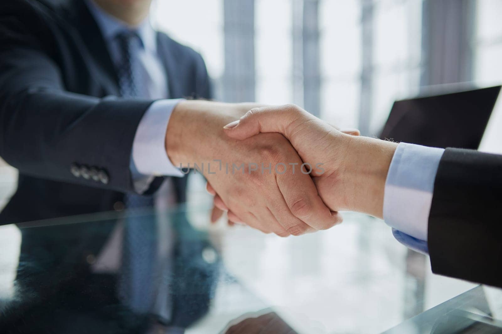 Real estate broker agent Shake hands after customer signing contract document for ownership realty purchase in the office by Prosto