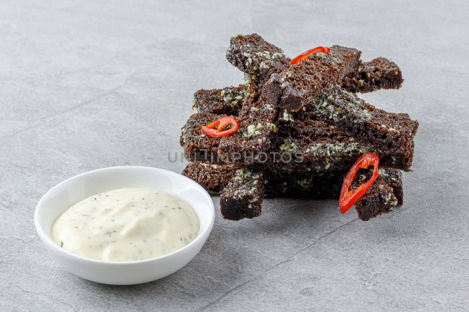 fried slices of black bread on a stone background studio food photo