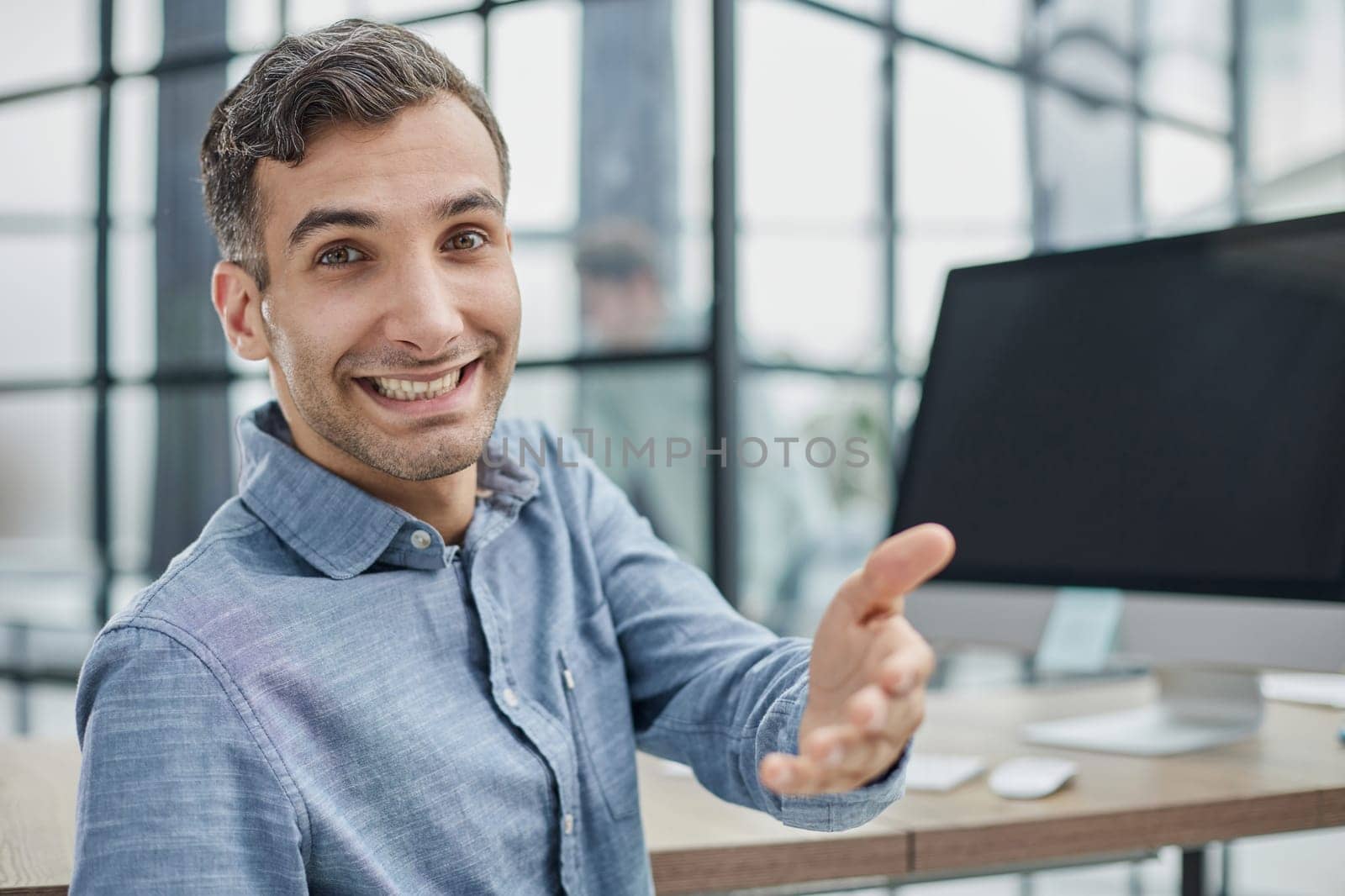 Young businessman holding handshaking after good deal