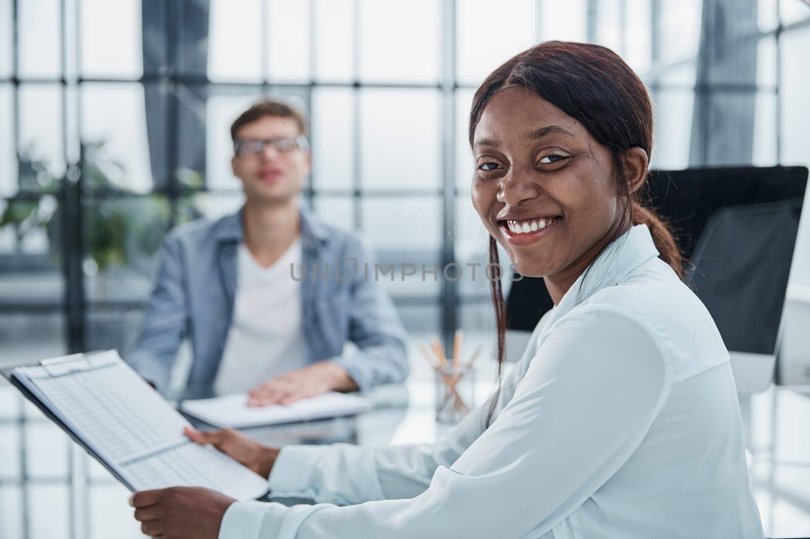 Smiling businesswoman taking interview of a job applicant