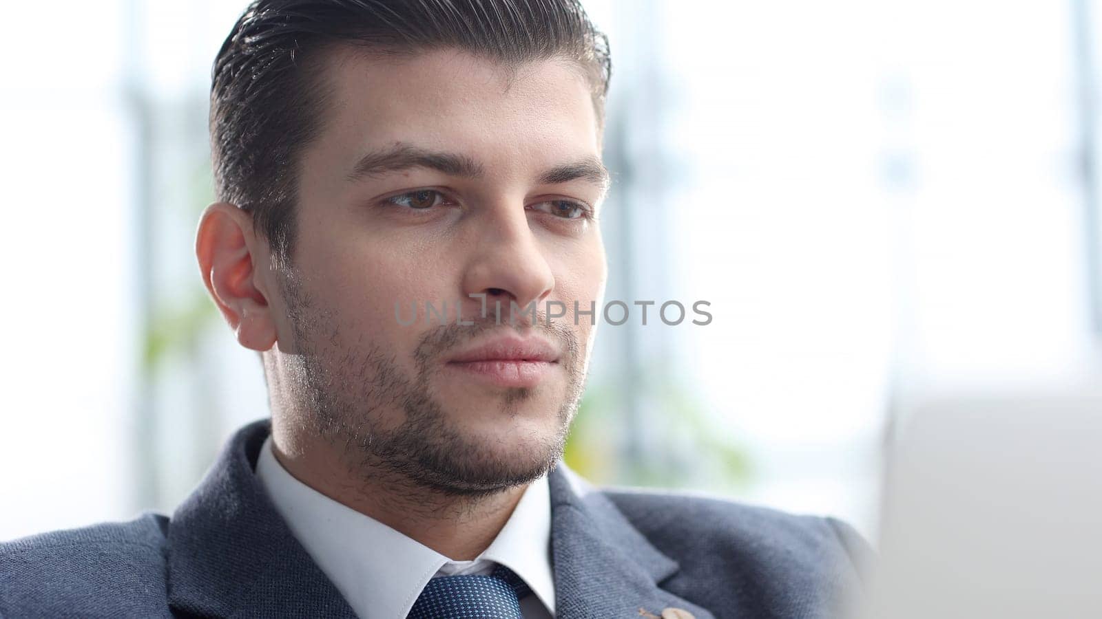 A male businessman works in an office.