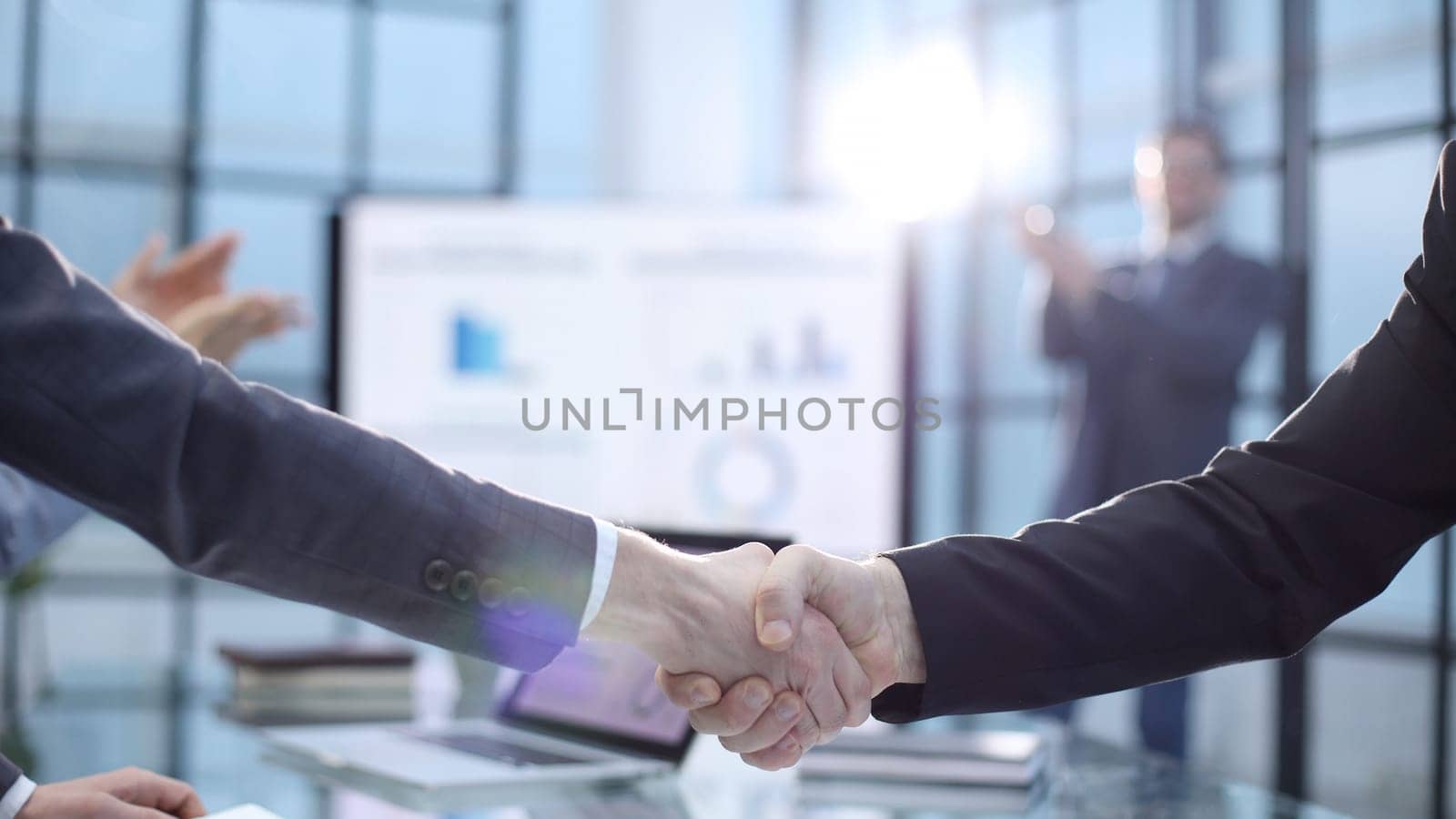 Congratulations on a successful deal with a handshake.