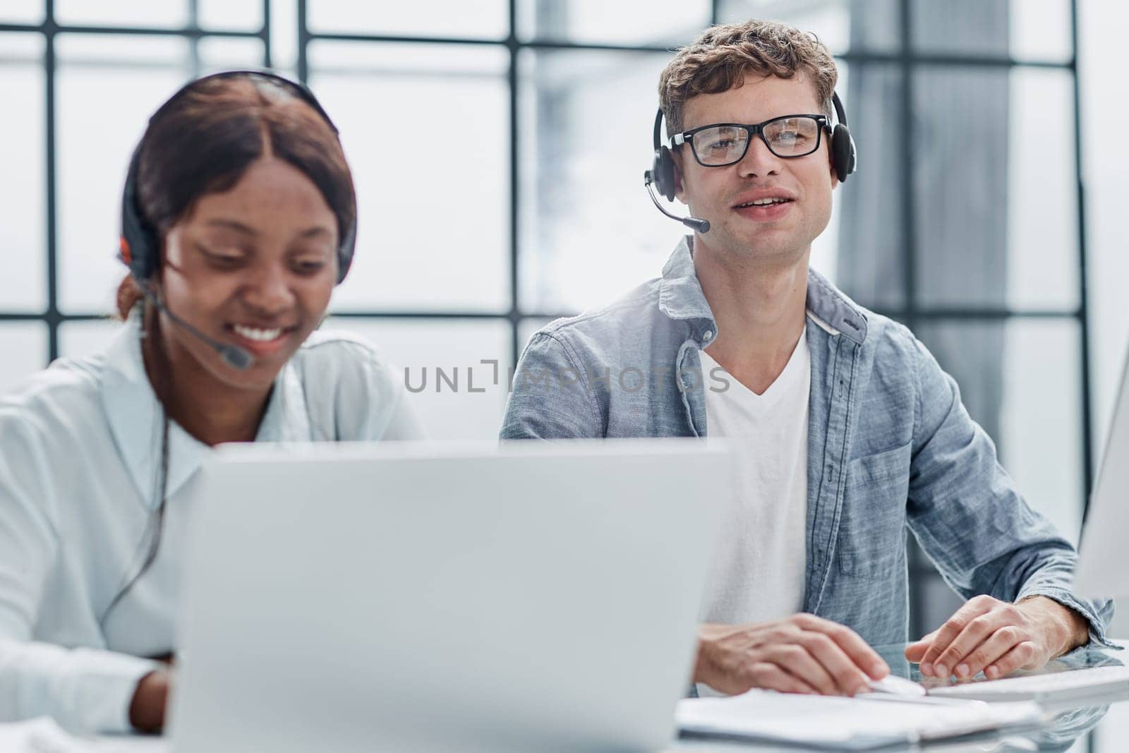 friendly operator woman agent with headsets working in a call center