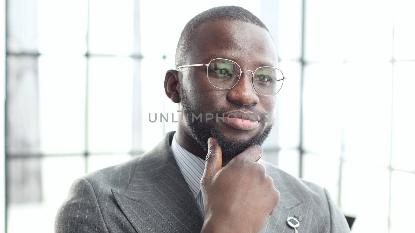 The face of a businessman man in close-up, he is thinking in the office.