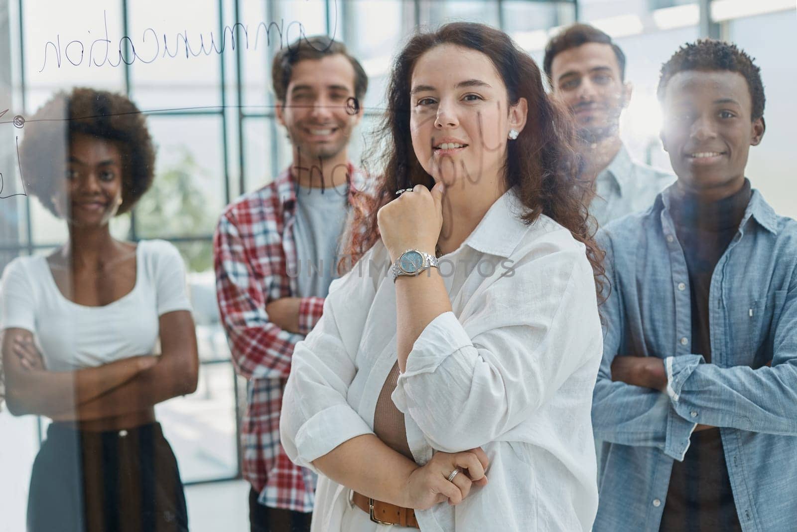 business woman with her staff in background at office by Prosto