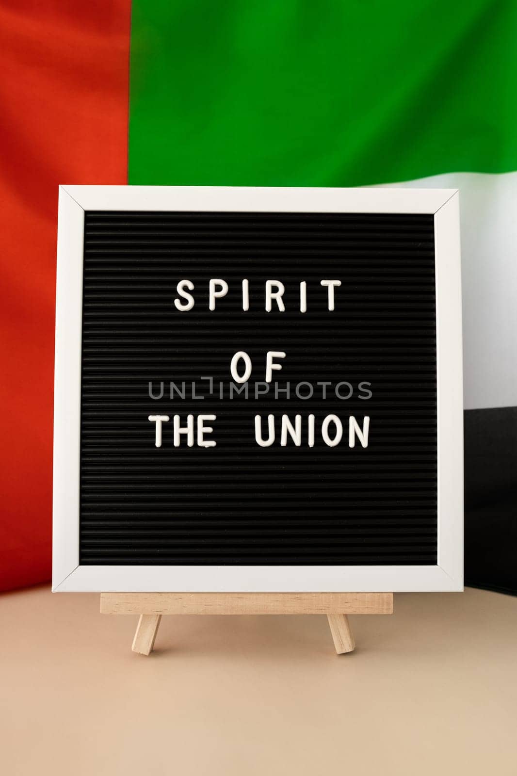 SPIRIT OF THE UNION text frame on United Arab Emirates waving flag made from silk material. Independence Commemoration Day Muslim Public holiday celebration background. The National Flag of UAE. Patriotism