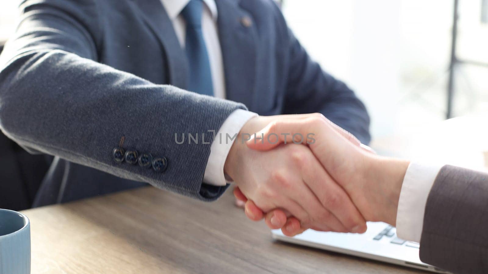 businessmen shake hands in close-up after a successful deal.