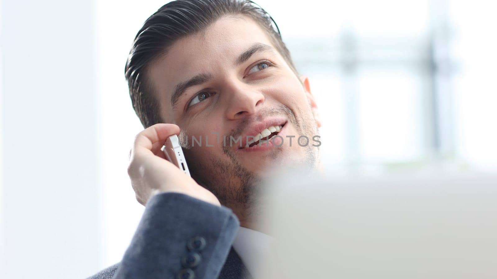 A male businessman is talking on the phone and negotiating a deal.