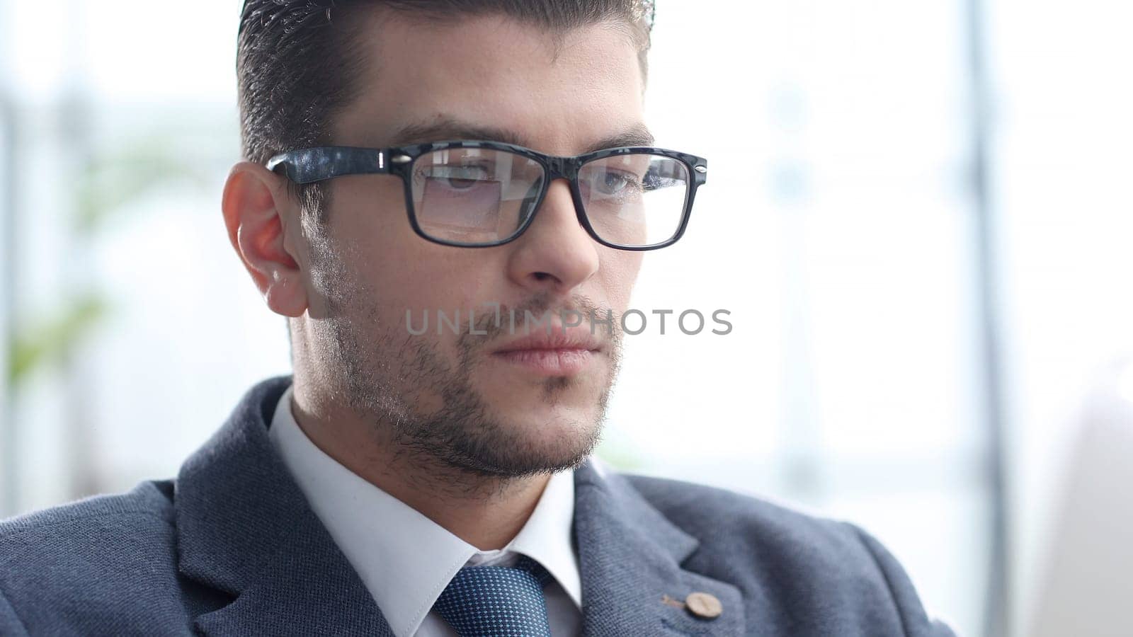 A male businessman works in an office.