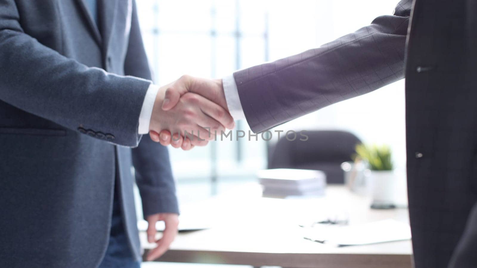Businessmen shake hands in the office.