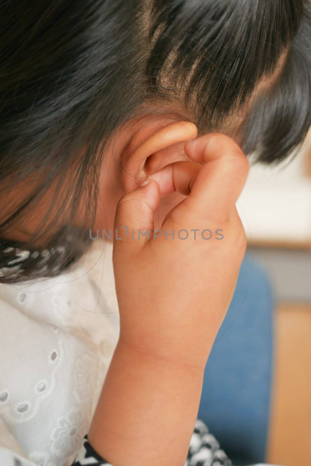 child having ear pain touching his painful ear , by towfiq007