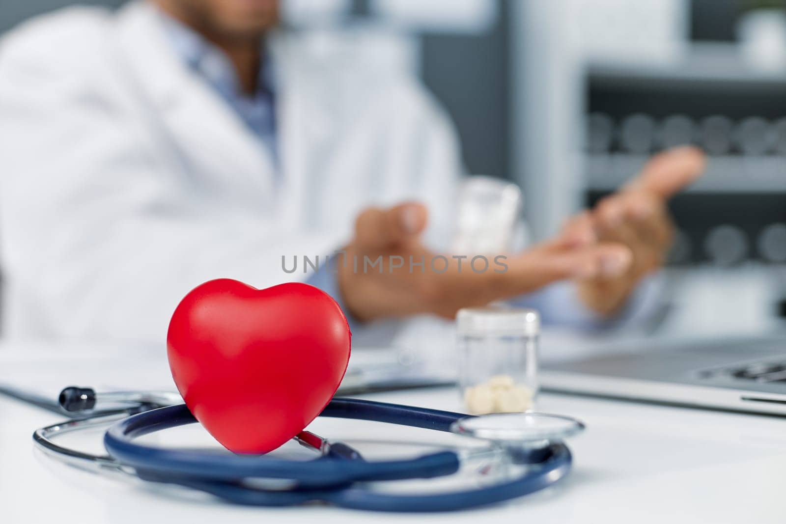 Stethoscope, red heart and cardiogram on gray table. Cardiology concept