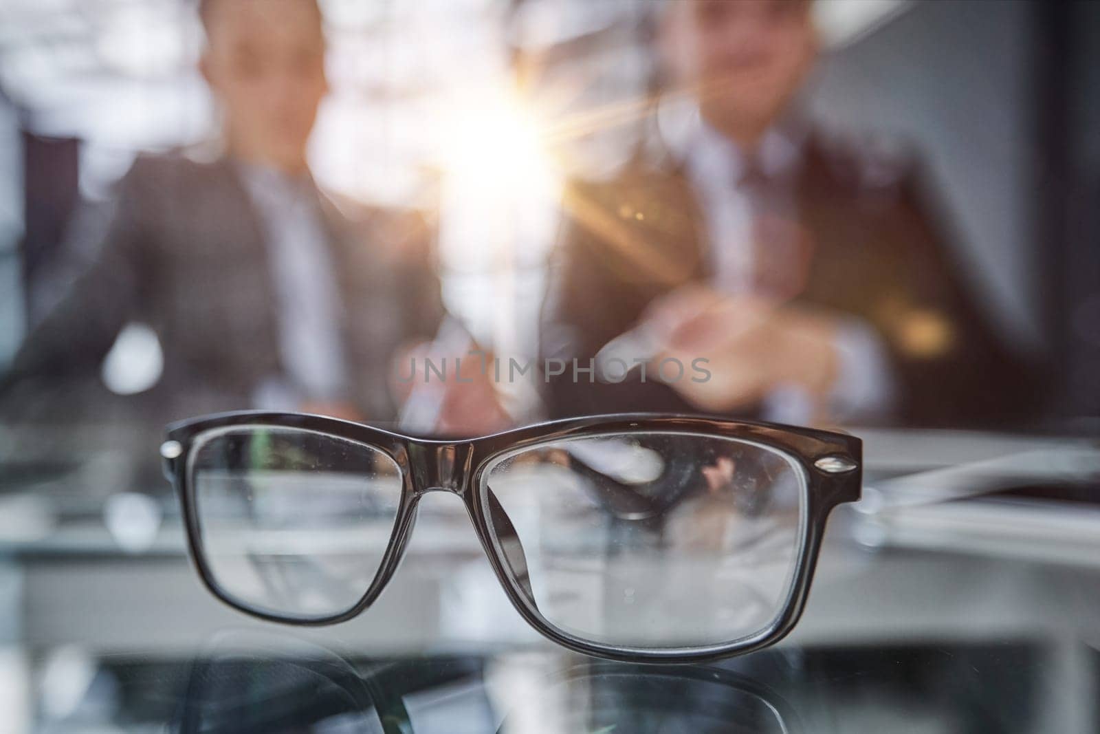 glasses on the table in the office on a blurred background of colleagues by Prosto