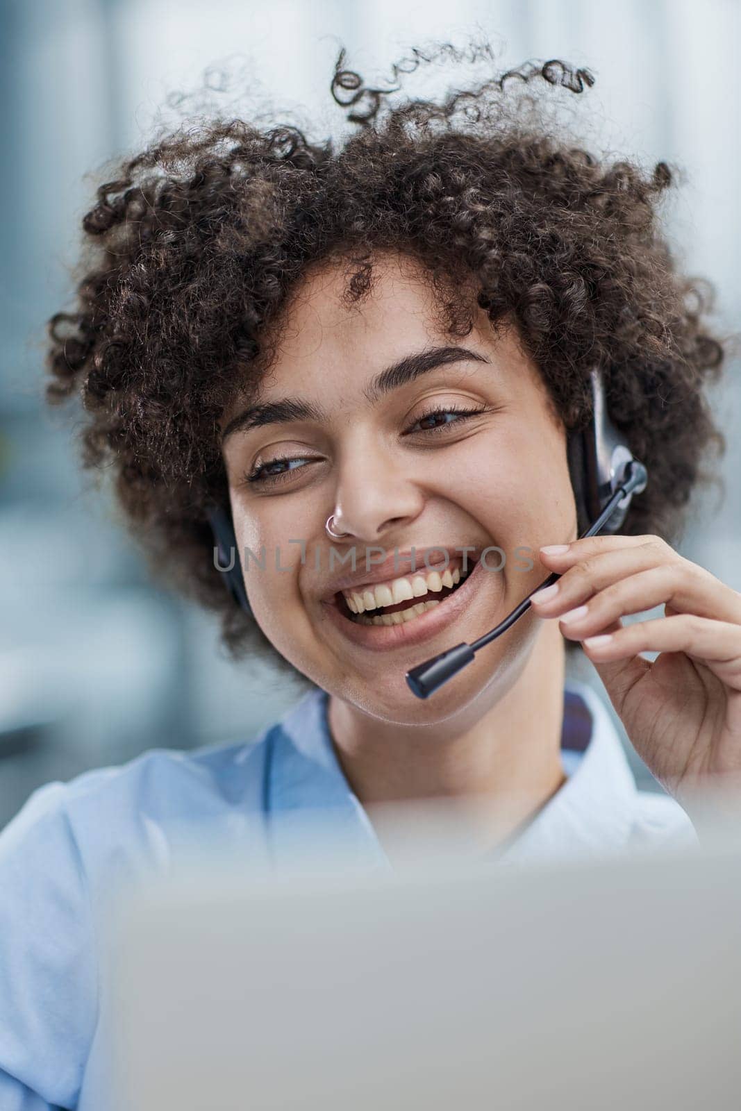 girl in a modern office working in a call center smiling.