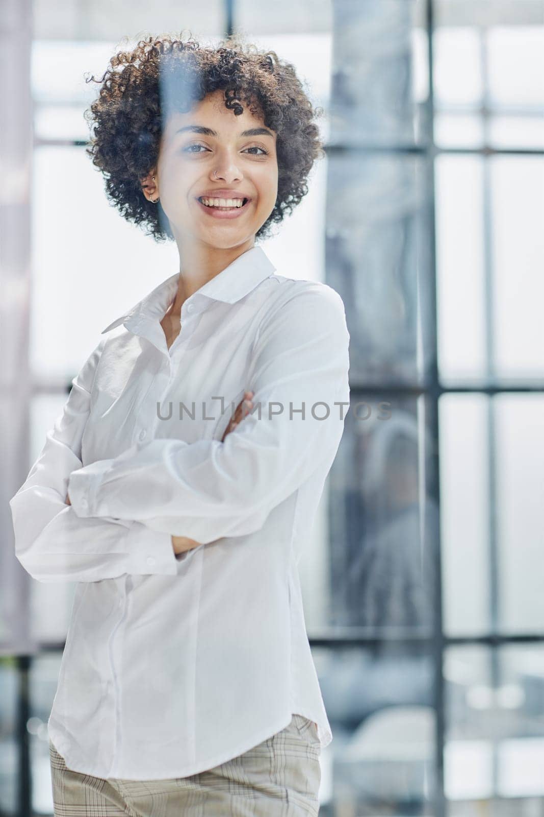 business woman looks admiringly into the distance through the glass at modern office