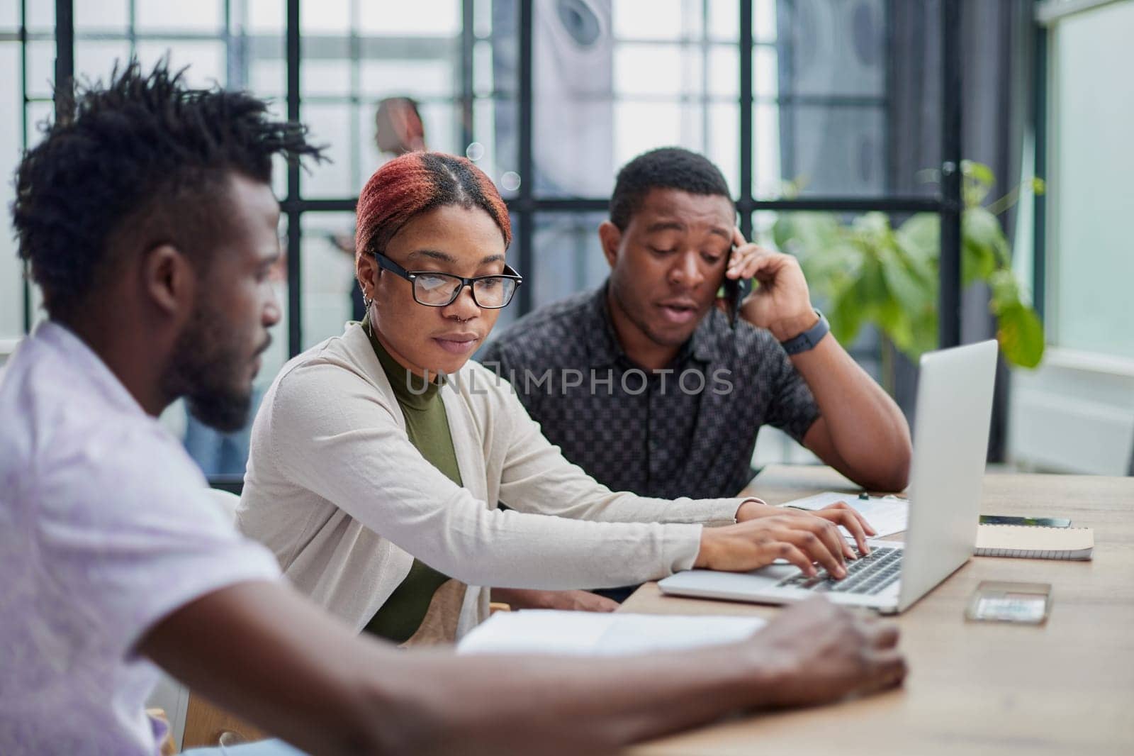 Young, motivated and experienced employees are brainstorming in the conference room.