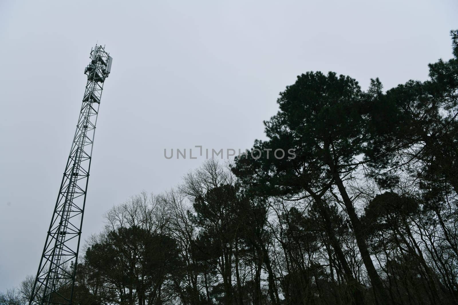 Deployment of the 5G network. Laying antennas on a mobile phone mast in the winter atmosphere. France, Gironde, February 2024. High quality photo