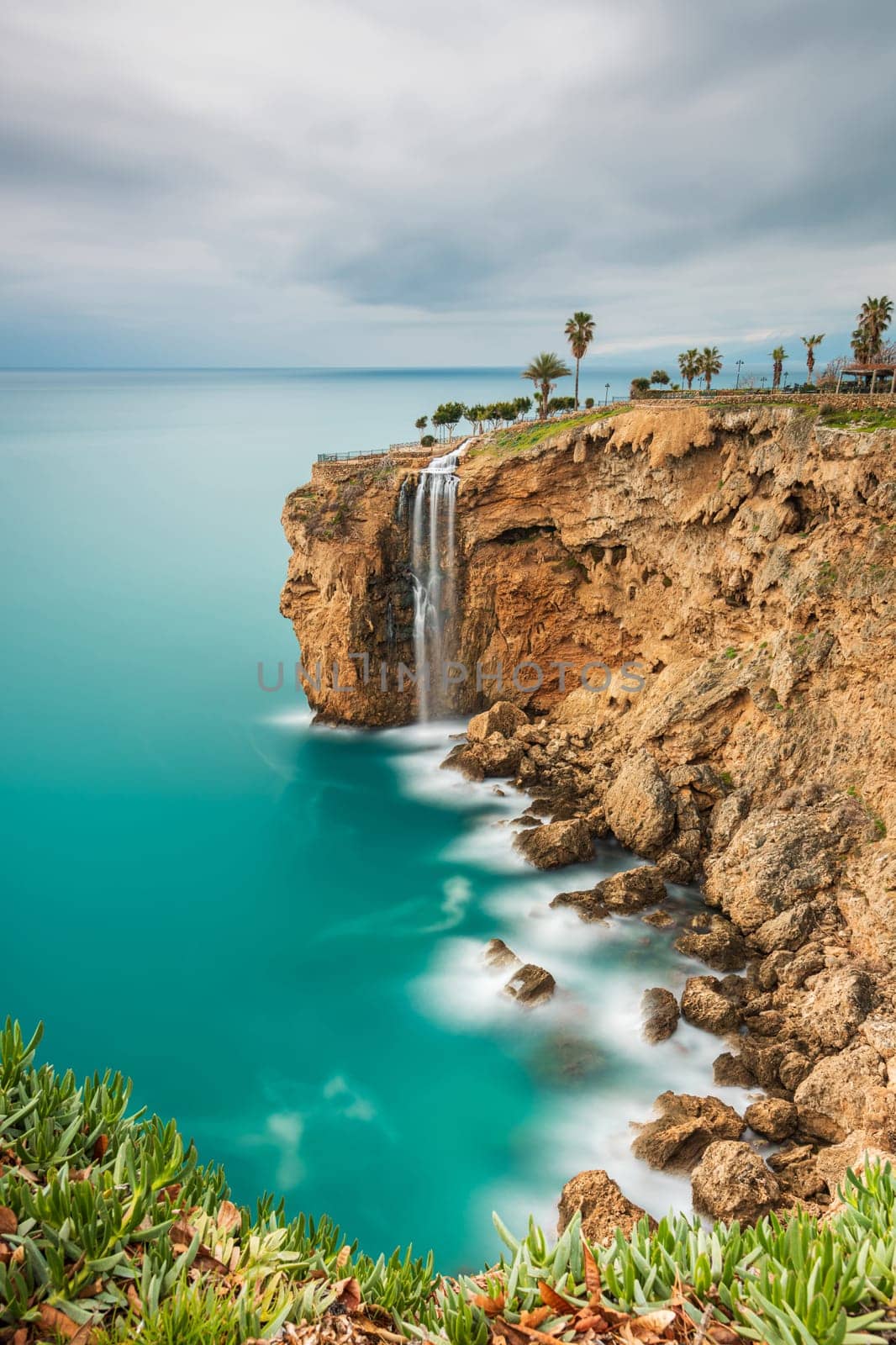 Long exposure image of the waterfall falling from the cliffs into the sea in Fener, Antalya by Sonat