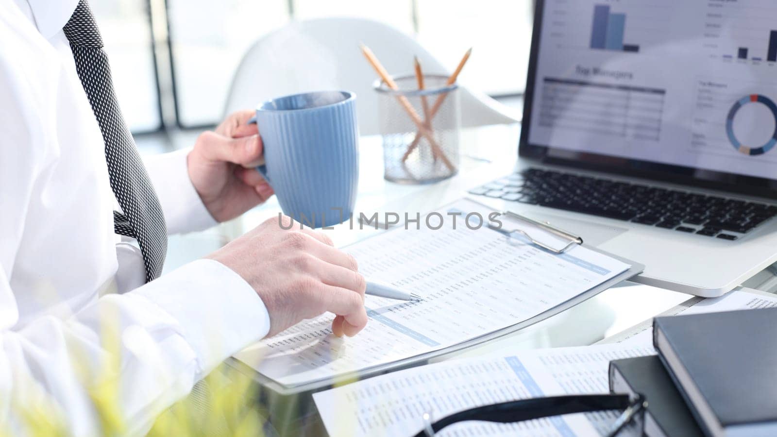 Comparing business reports with a cup of coffee by Prosto