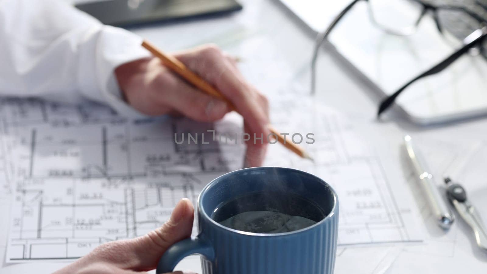 Drawing drawings and house layout with a cup of coffee.