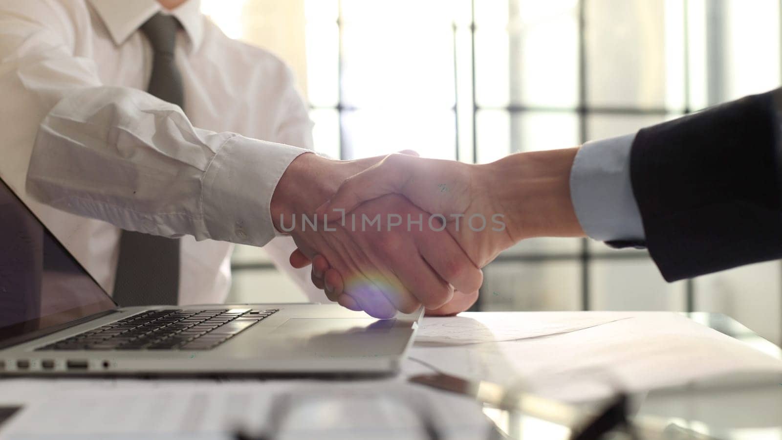 Handshake after a successful deal at a meeting.