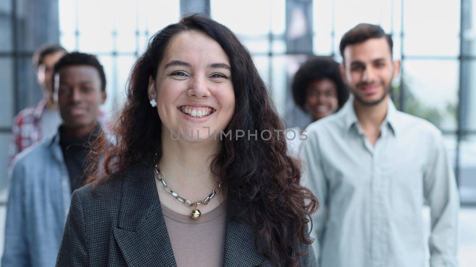 business woman with her staff in background at office by Prosto