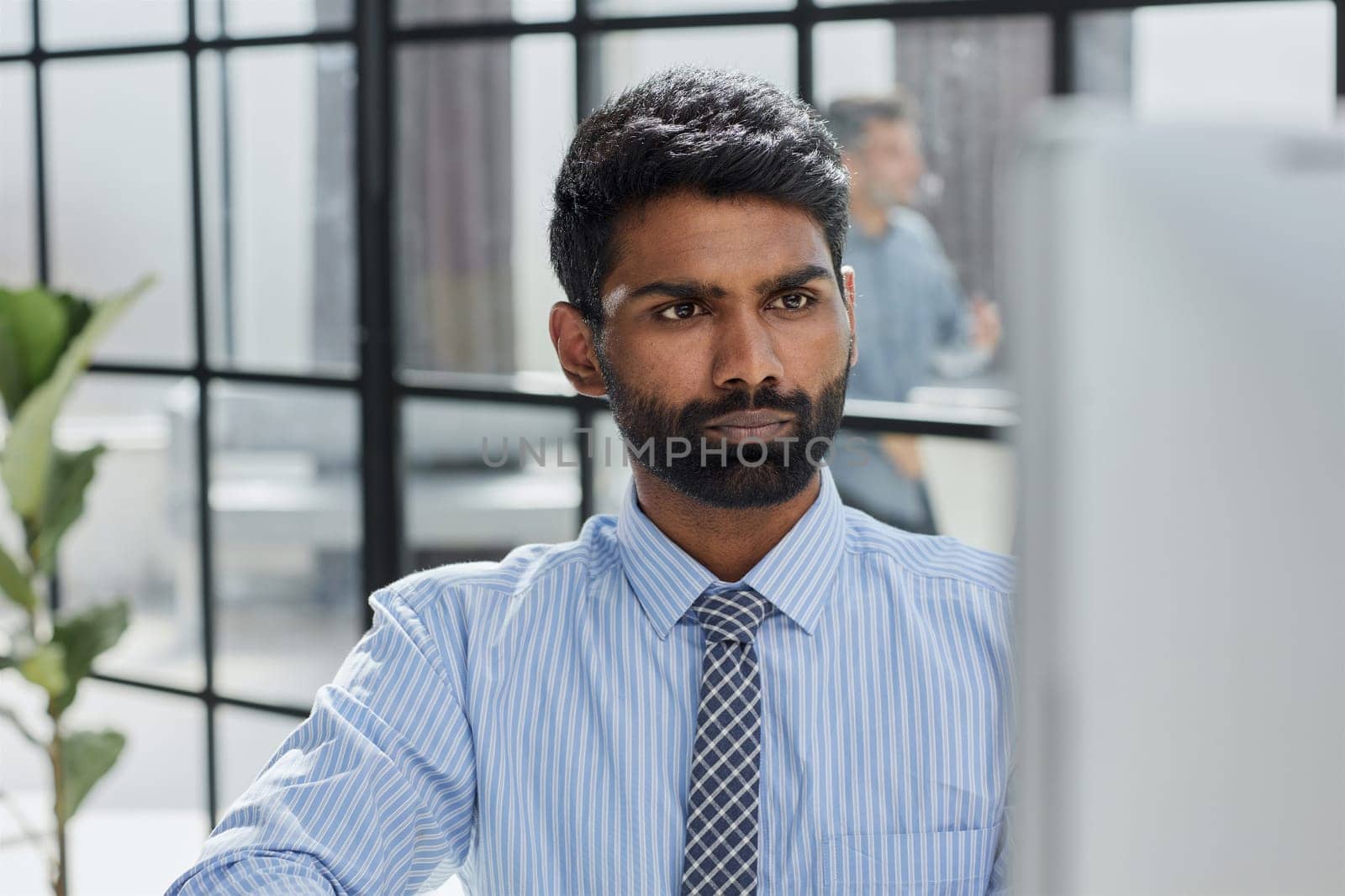 A pensive businessman working on laptop computer by Prosto