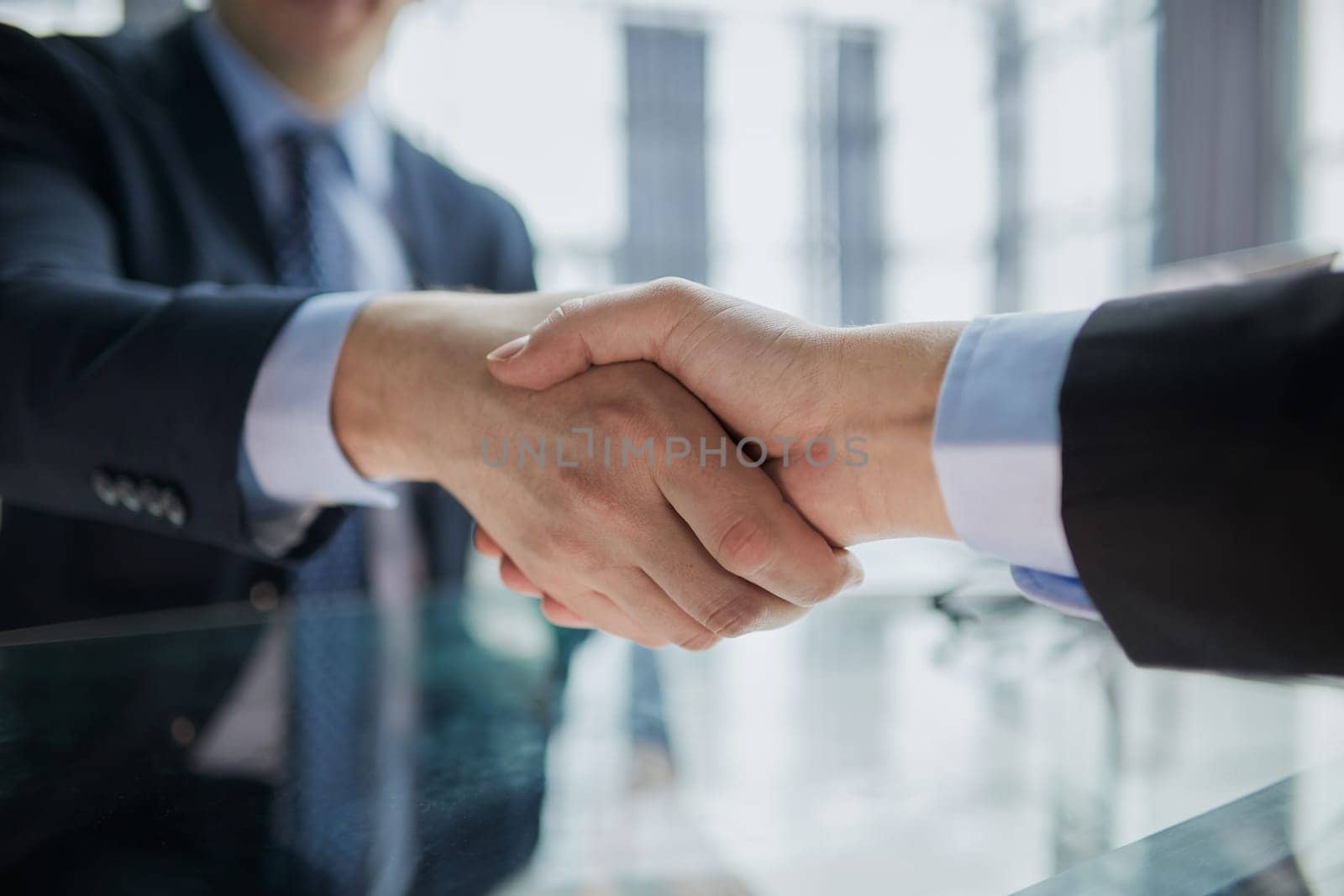 Real estate broker agent Shake hands after customer signing contract document for ownership realty purchase in the office by Prosto