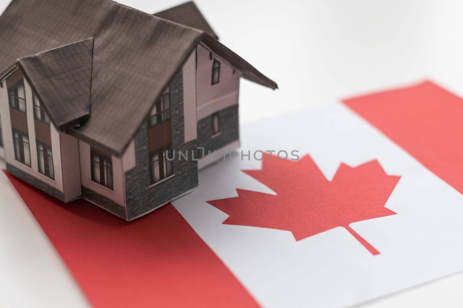 wooden house with flag of Canada Finance, investment, mortgage, loan and credit concept by Andelov13