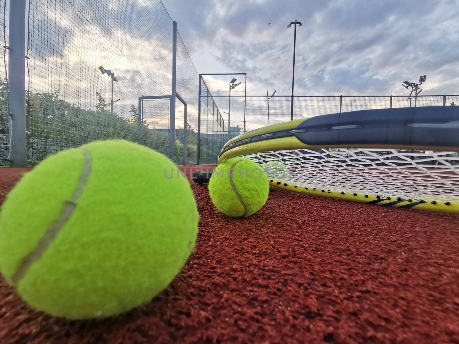 yellow tennis balls and two racquet on hard tennis court surface, top view tennis scene. High quality photo