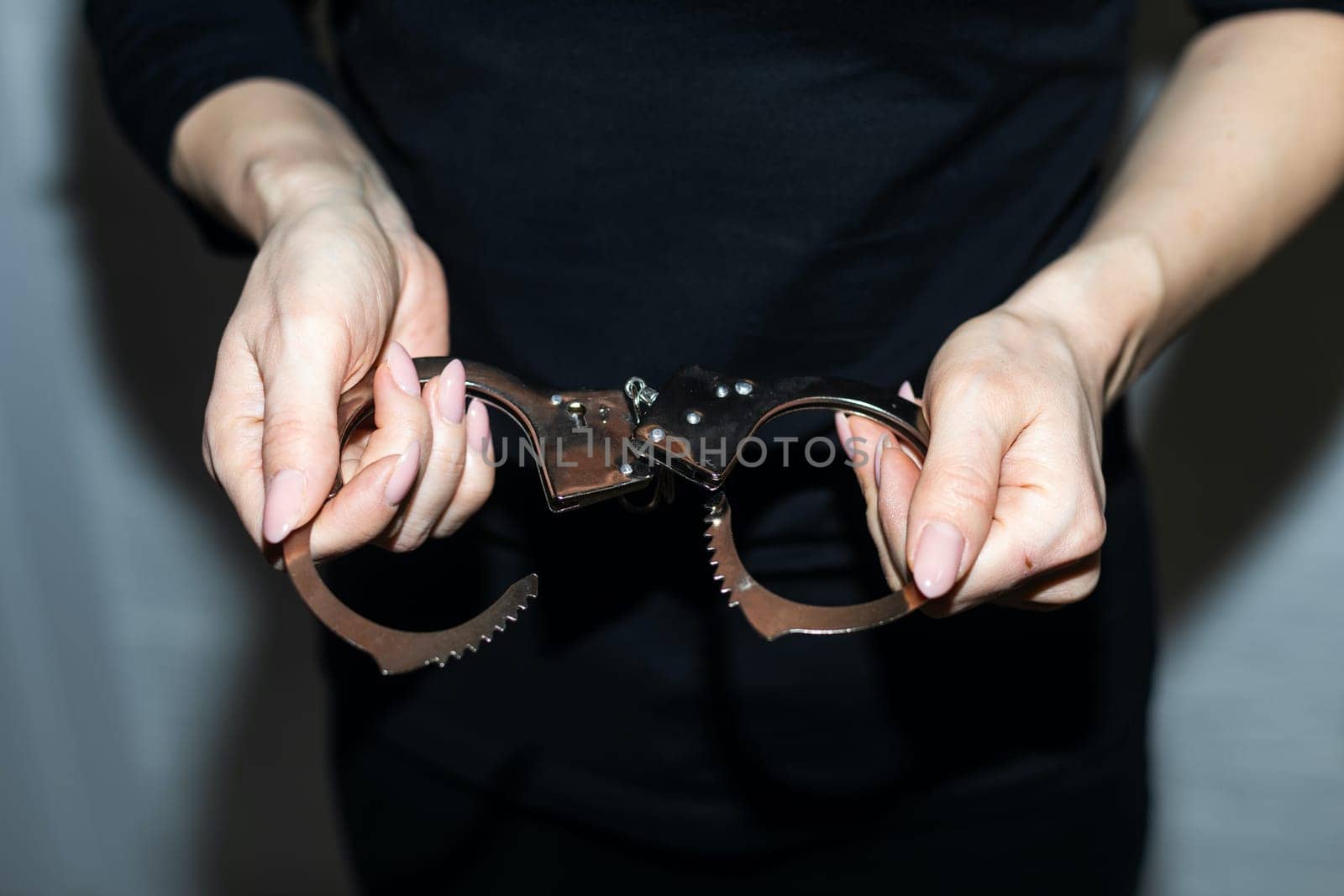 hand squeezing metal handcuffs, the concept of freedom justice. High quality photo