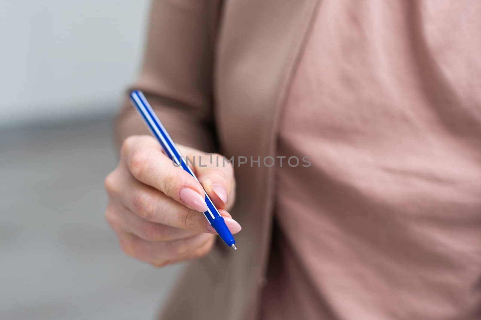 Using a hand hold the pen for writing. High quality photo
