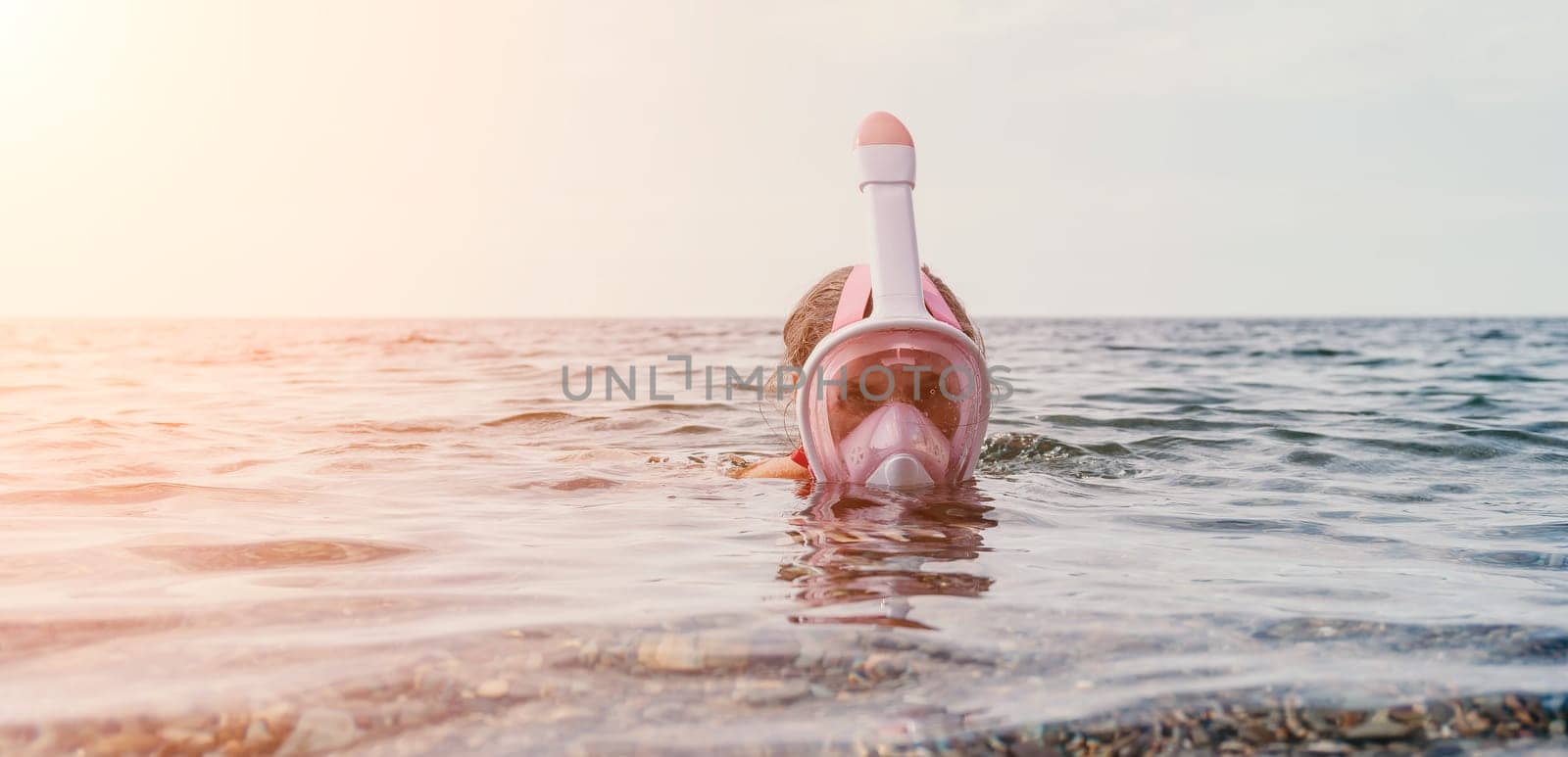 Young happy woman in white bikini put pink snorkeling mask on beach before swimming. girl having fun relaxing on beautiful beach. Beach lifestyle