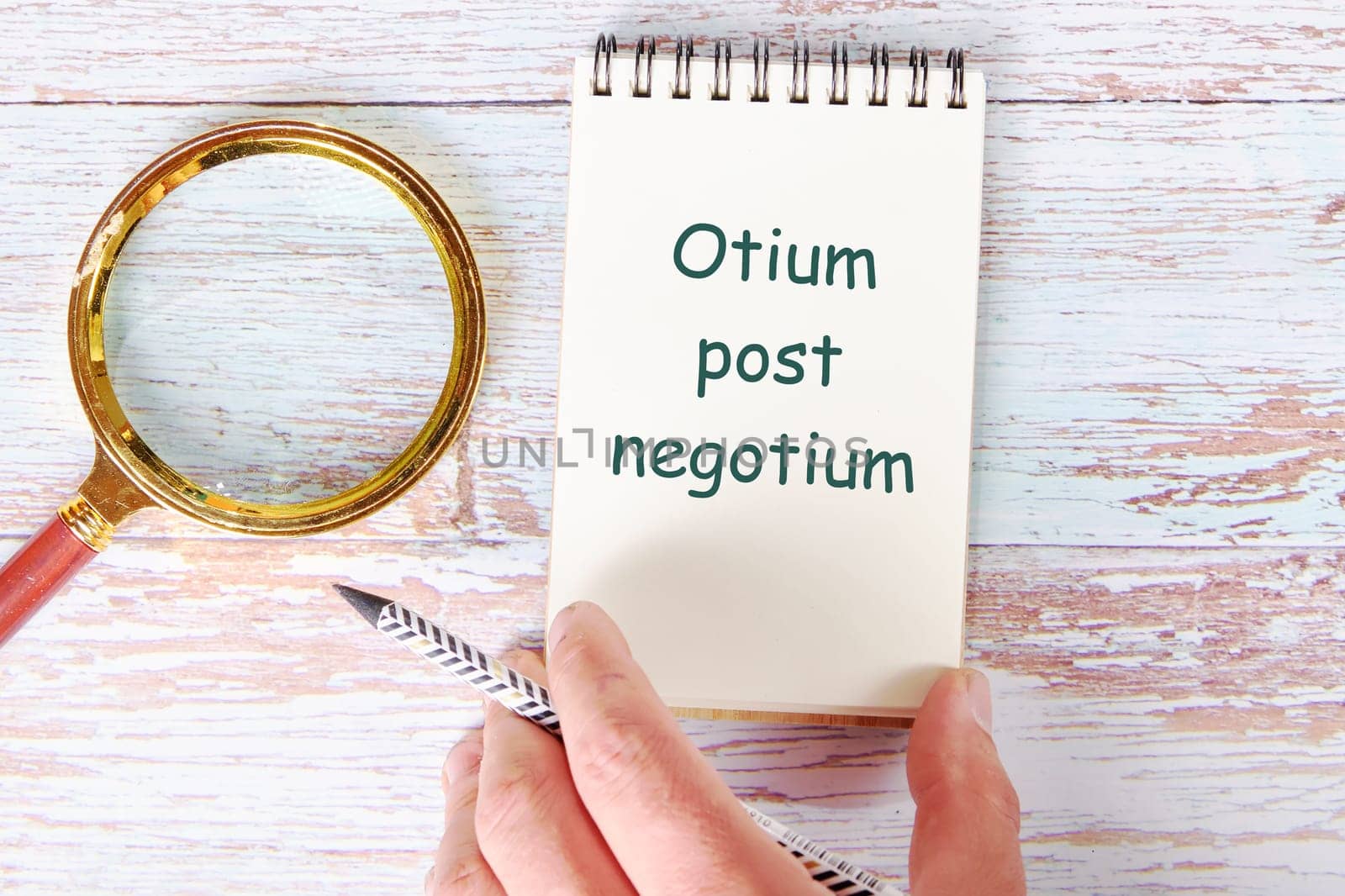 Otium post negotium It is translated from Latin as, Rest after the case It is written in a clean open notebook