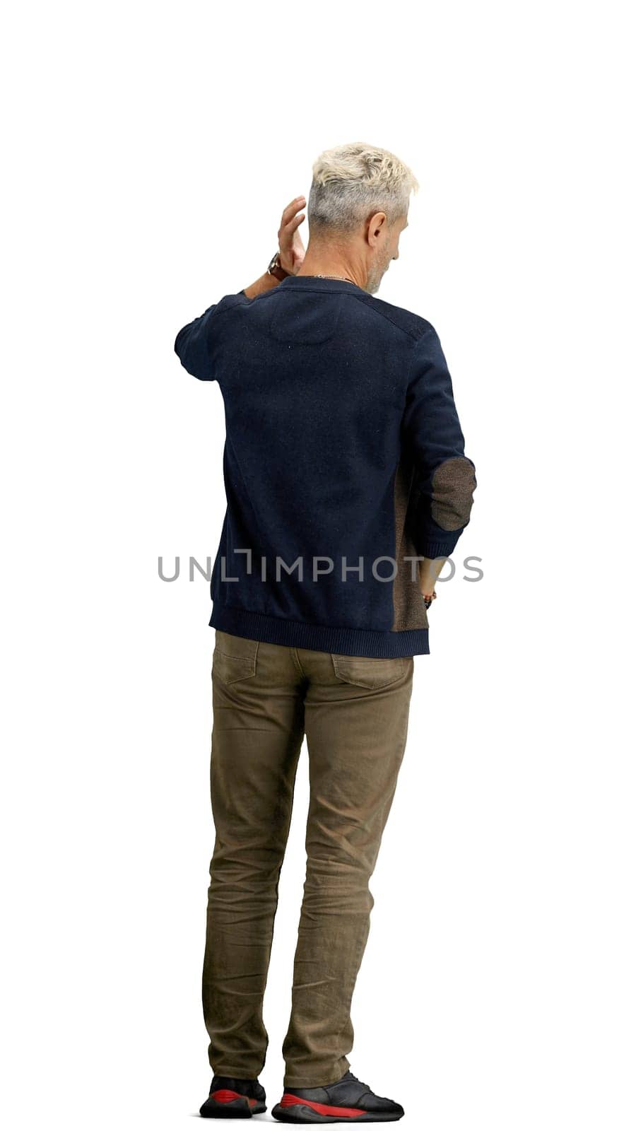 A man, full-length, on a white background, clutched his head.